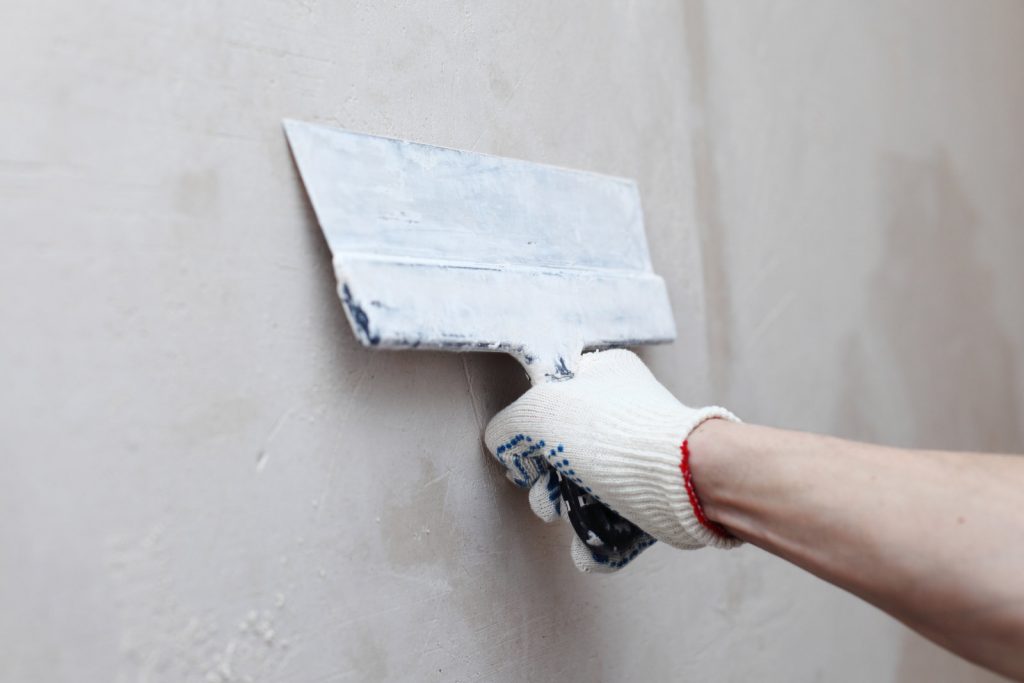 man applying plater on the wall
