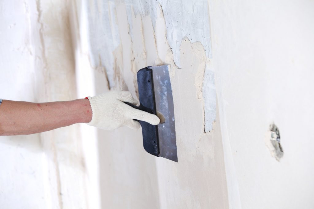 construction worker applying plaster on the wall